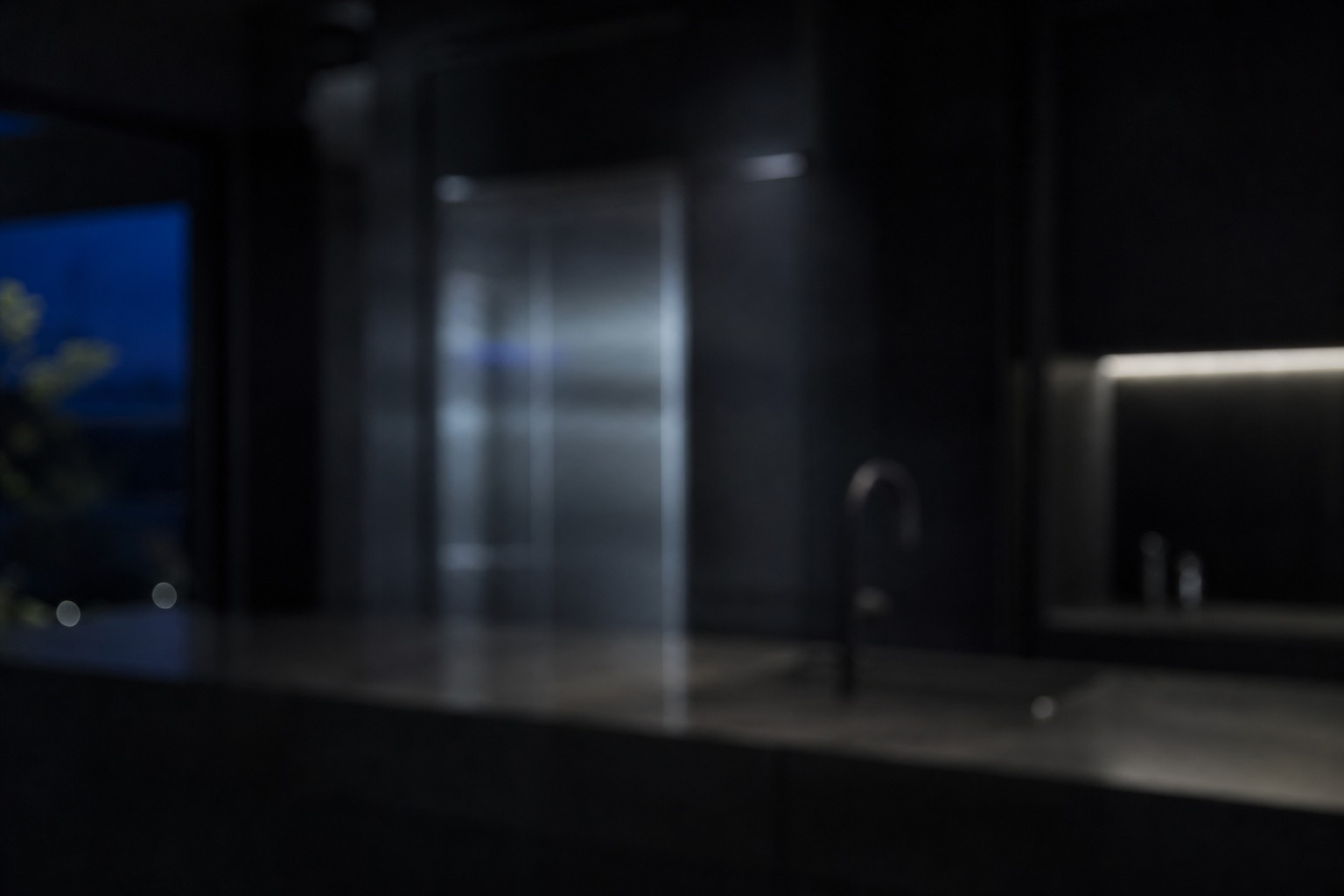 Dark minimal Cupertino kitchen at night with cool stainless highlights